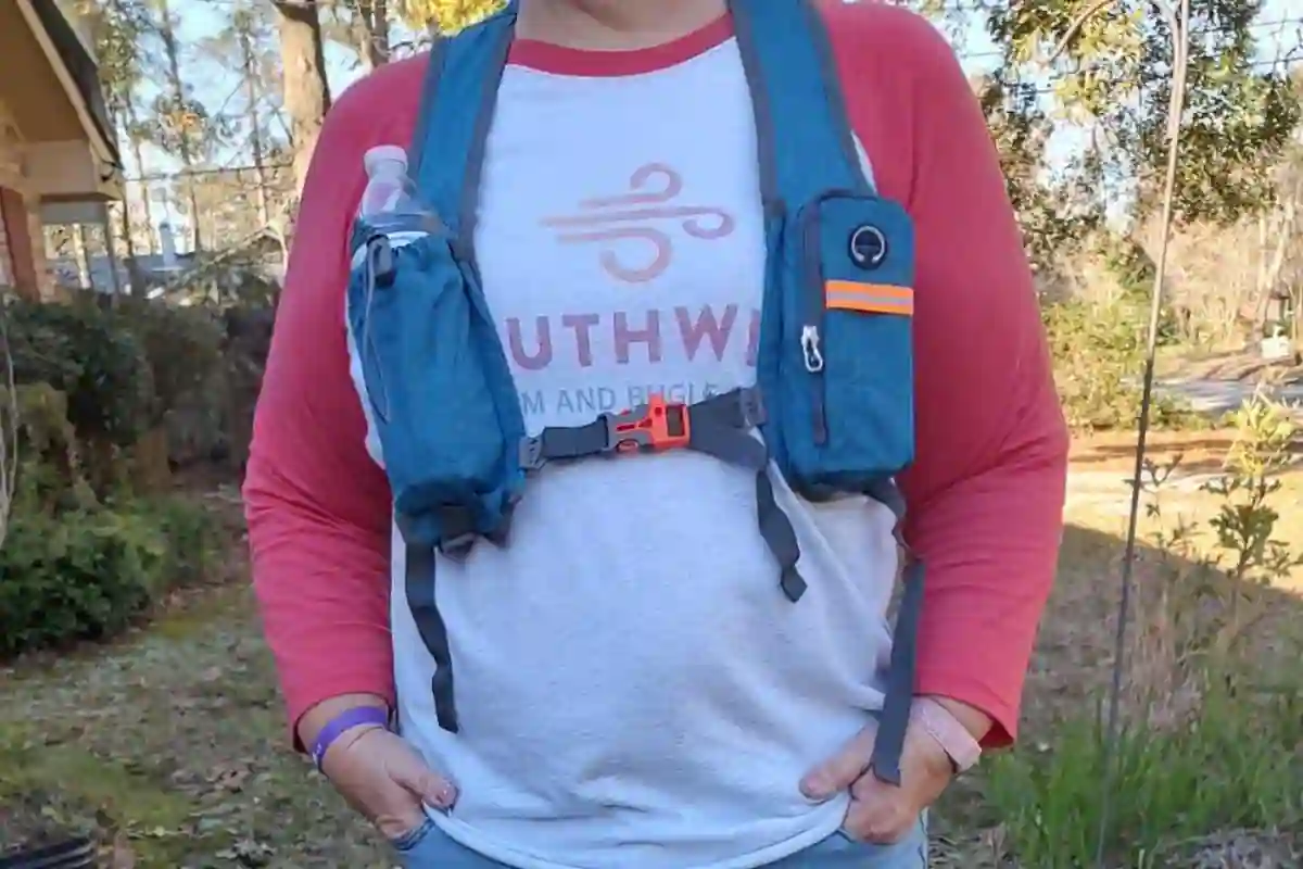 Backpack with a small shoulder strap pocket holding a phone, Metro card, and earbuds for easy access.