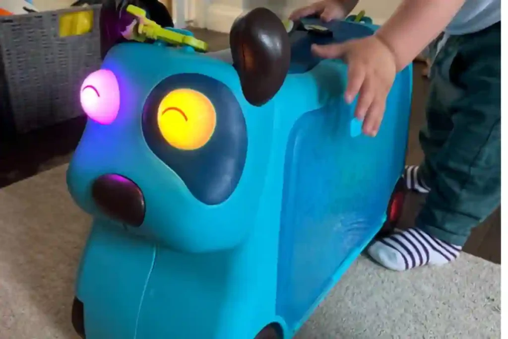Kid riding JetKids BedBox suitcase that converts into airplane bed