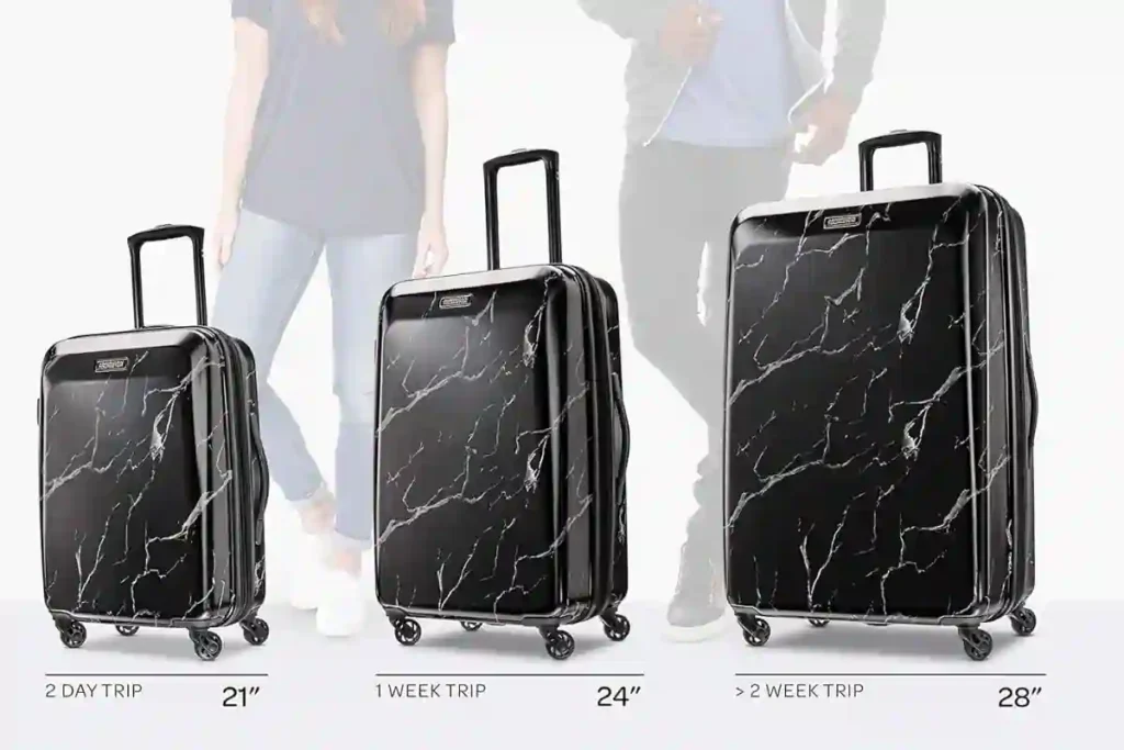 Sleek black marble design three-piece American Tourister hard shell suitcases.