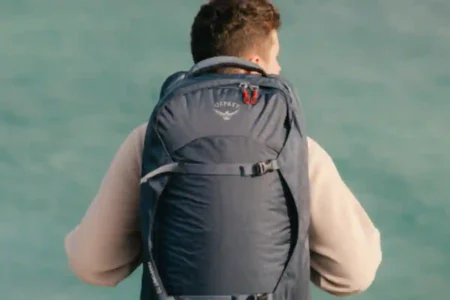 Traveler with a modern carry-on backpack at the airport ready for flight, representing top tested backpacks for 2025.