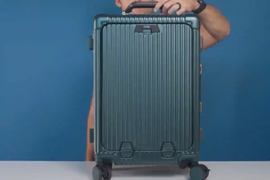 NOBL suitcase showing soft-close handles, spinner wheels, and TSA-locked front laptop compartment.