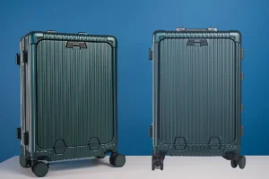 NOBL All-in-One Carry-On suitcase standing in an airport terminal, showcasing its sleek hard-shell design and gadget-packed features.