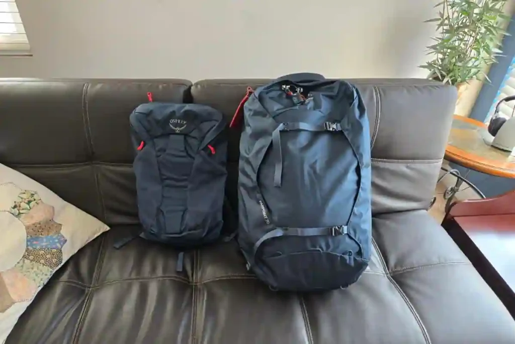 Best 35L–40L Carry-On Travel Backpacks for Flights (2026 Tested Guide) 9 Traveler taking Osprey Farpoint 40 backpack near the coast