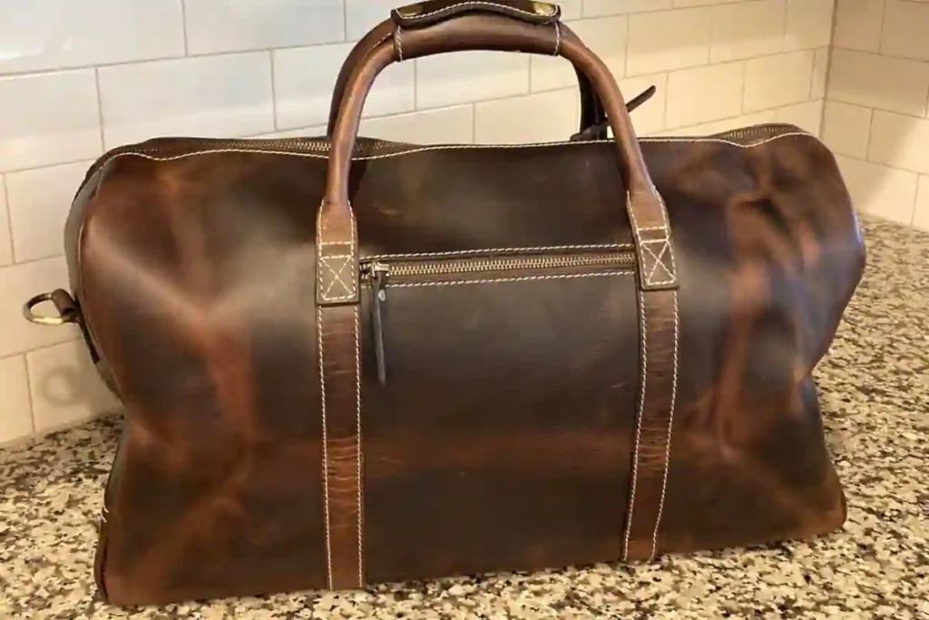 Best Leather Duffel Bags of 2026: Expert Picks for Travel, Work & Weekend Trips 2 Rustic Town full-grain buffalo leather travel duffel bag with brass hardware and reinforced stitching.