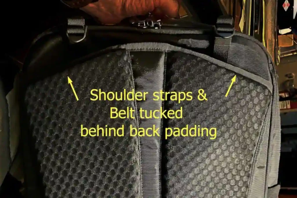 Back view of a Tortuga 25L travel backpack with shoulder straps and waist belt neatly tucked behind the padded back panel for carry-on travel.