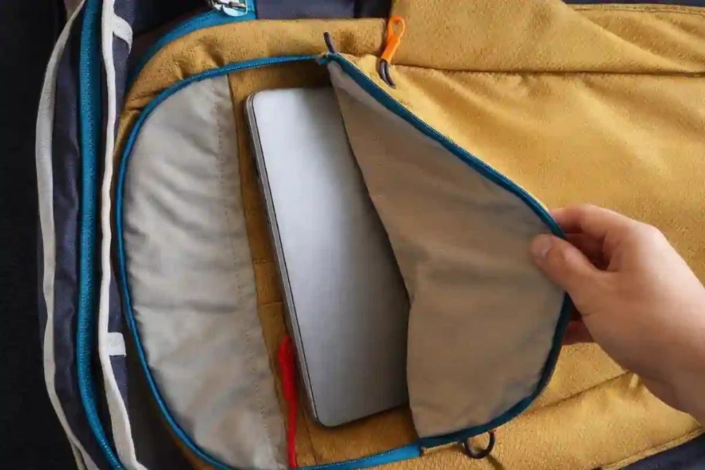 Osprey Daylite Carry-On Travel Pack 35L Review – Lightweight & Practical 5 Osprey Daylite 35L rear laptop compartment showing MacBook Pro inside, with protective false bottom for travel safety