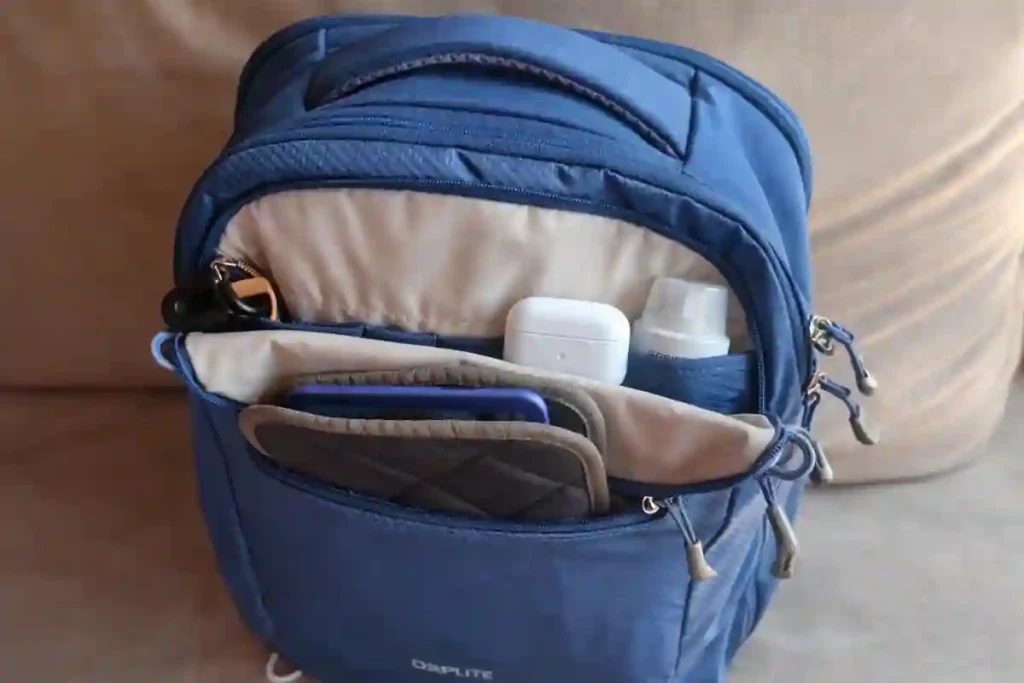 Osprey Daylite 26+6 Review: Is This the Best Travel Backpack for One Bag Travelers? 3 16-inch laptop being inserted into the padded rear-access tech sleeve of the Osprey Daylite backpack.