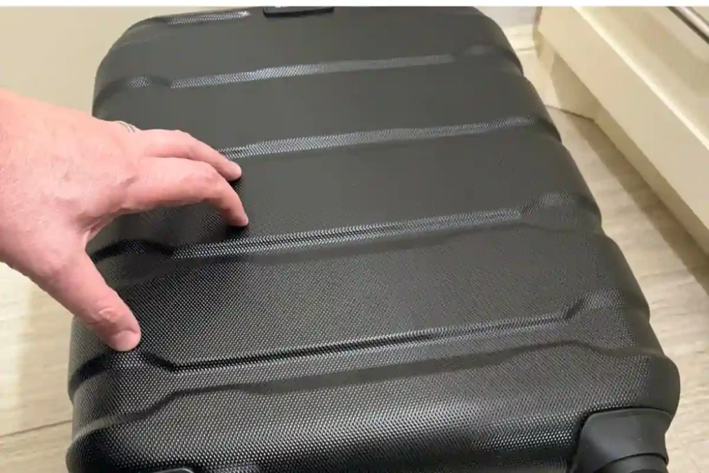 Samsonite Omni PC hard-shell luggage after multiple flights showing minimal scratches and solid wheel condition