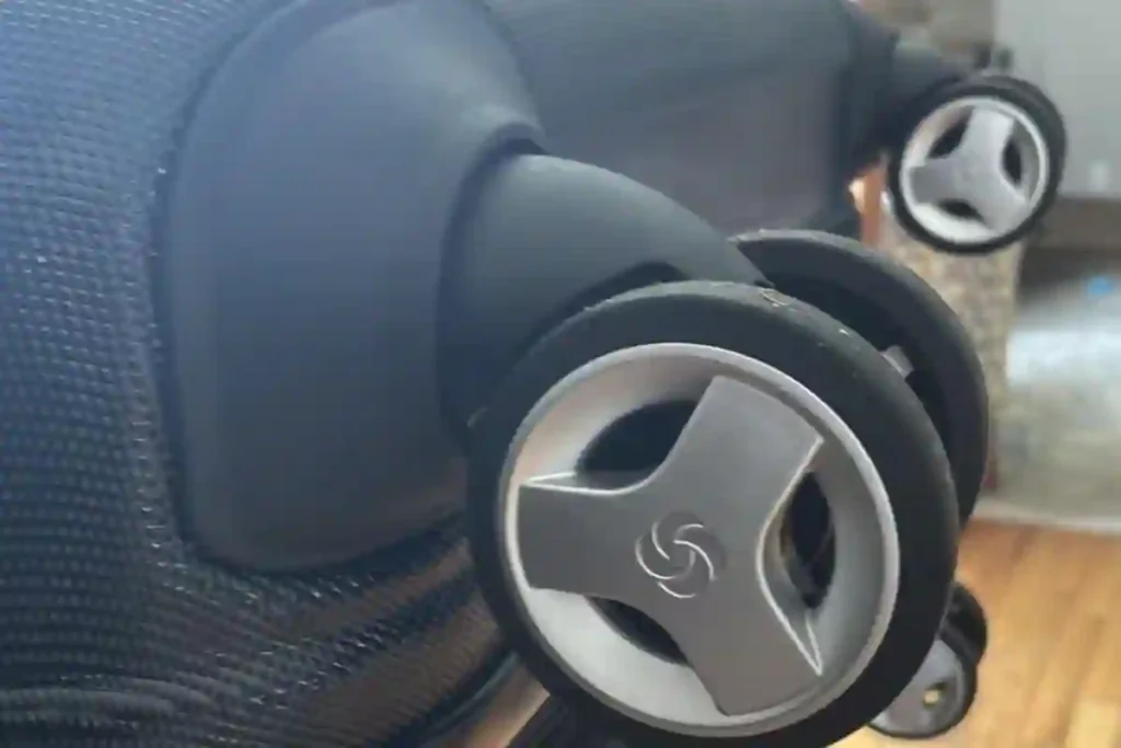 Samsonite Omni PC 360-degree spinner wheels moving smoothly across an airport terminal floor